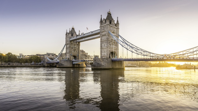 Tower Bridge over the River Thames in London at sunrise.