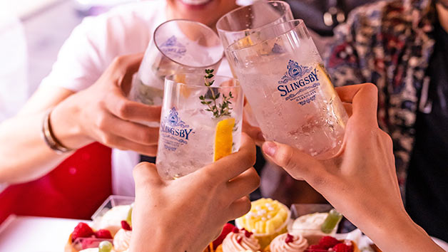 Sip on gin as you take in the sights. Image courtesy of Red Letter Days. People cheers glasses of gin together.