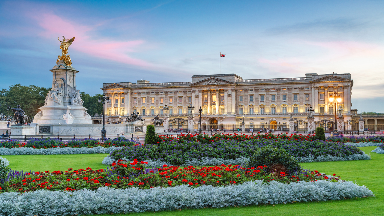 See Buckingham Palace, the heart of the British monarchy and residence of King Charles III. Image courtesy of Jon Reid. Exterior of Buckingham Palace during sunset.