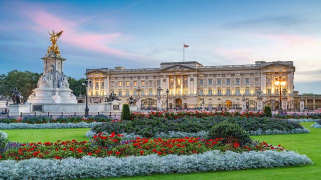 Exterior of Buckingham Palace during sunset.