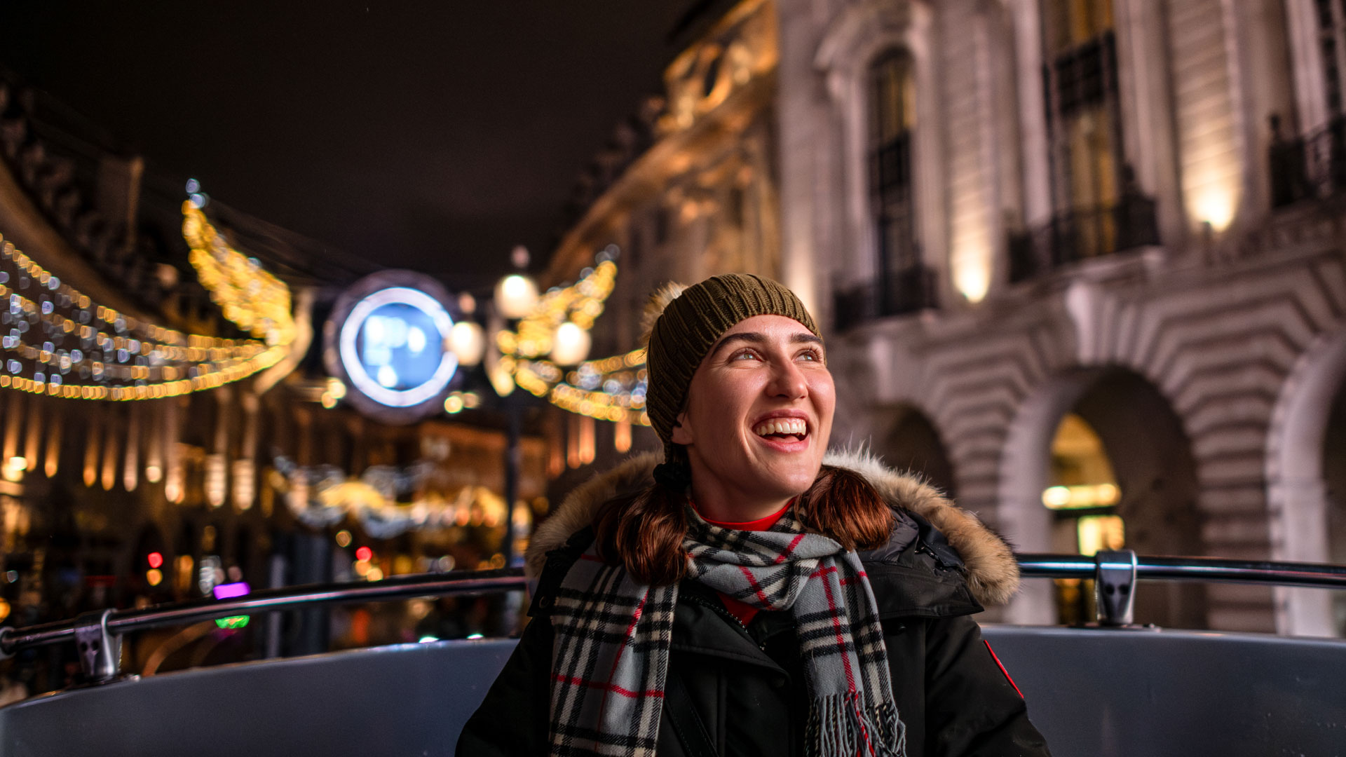 Discover the magic of London this festive season on a Christmas lights open-top bus tour. Image courtesy of Michael Barrow. A young woman sitting on the top deck of the Christmas Bus Light Tour seemed delighted by the spectacle.