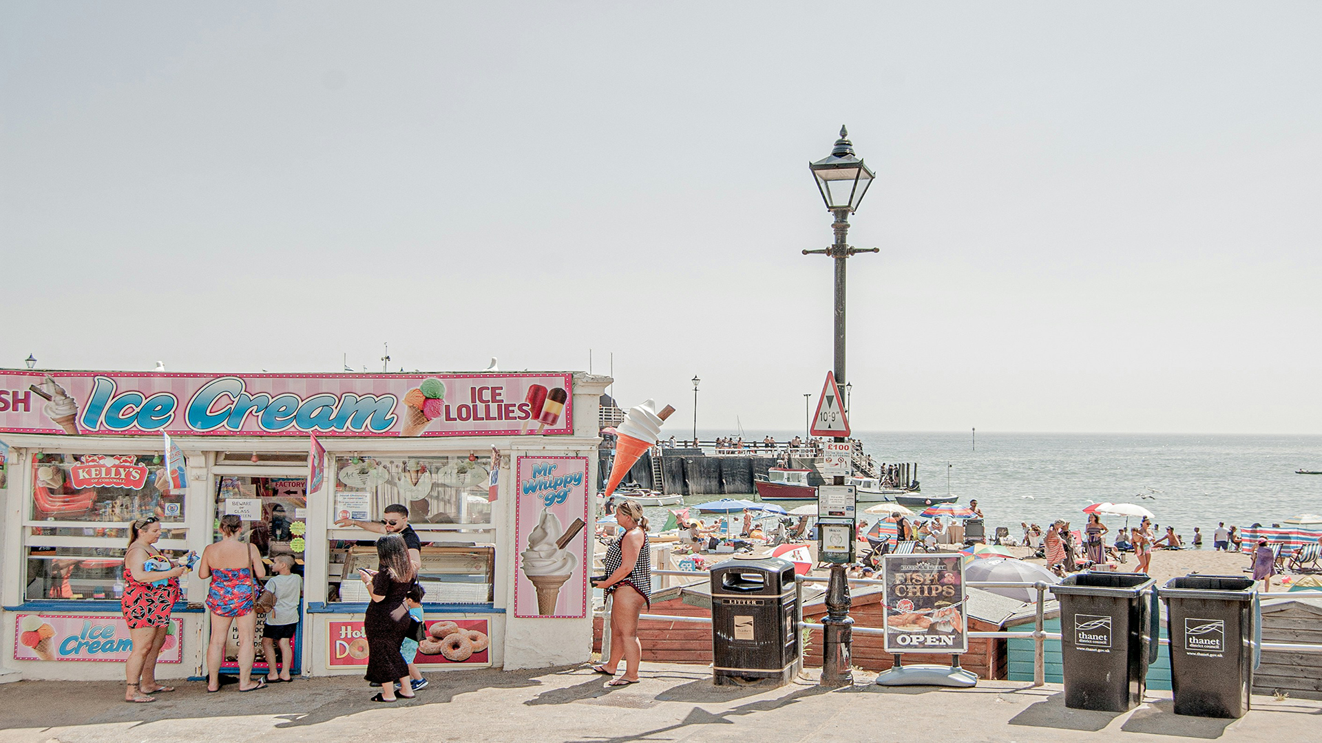 Broadstairs, Kent. Photo by Ferran Feixas on Unsplash. People queuing for ice cream by the beach in Broadstairs on a busy summer's day.