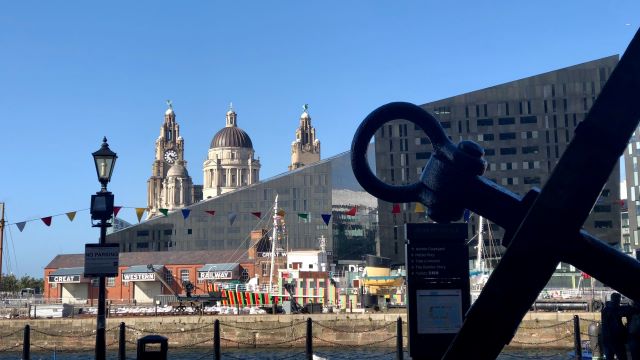 A snapshot view of the Liverpool docks. Photo by megan on Unsplash. Liverpool cityscape with modern and old buildings lining the docks.