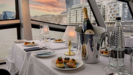 Tuck into a delicious four-course meal on a Thames dinner cruise. Image courtesy of Golden Tours.