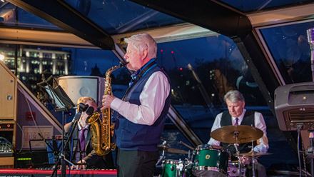Enjoy an elegant night out on the Thames jazz dinner cruise, featuring live jazz performances and breathtaking views of London's illuminated skyline. Image courtesy of Golden Tours