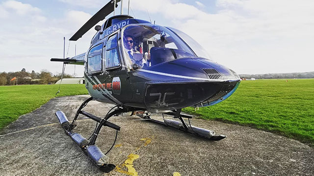 Take off from a number of locations © Adventure 001. Image courtesy of Adventure 001. A helicopter pilot sitting in a helicopter on the ground.
