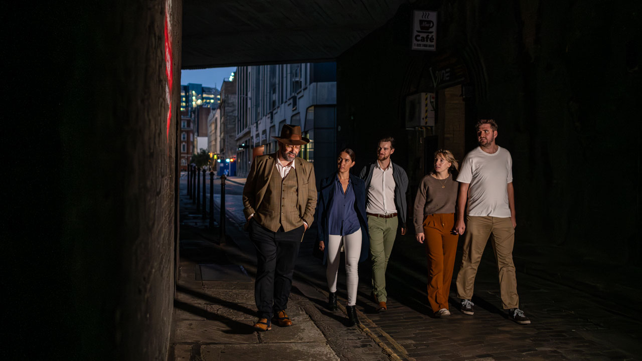 Travel back to Victorian times and uncover the mystery that surrounds the infamous Jack The Ripper. ©London & Partners/Michael Barrow A group is led by a tour guide on a Jack The Ripper guided walk through a dark alleyway in East London.