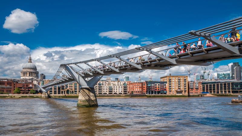 Learn about Millennium Bridge, a steel suspension bridge for pedestrians, linking Bankside with the City of London. Credit: Shutterstock. Image courtesy of Shutterstock. low angle shot of the steel bridge, built across the river Thames connect central London to south London.