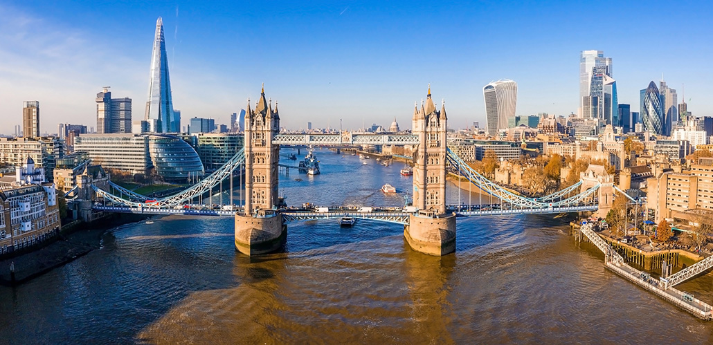 An aerial view looking across to Tower Bridge and the Thames, with The Shard on the left and the City of London on the right.