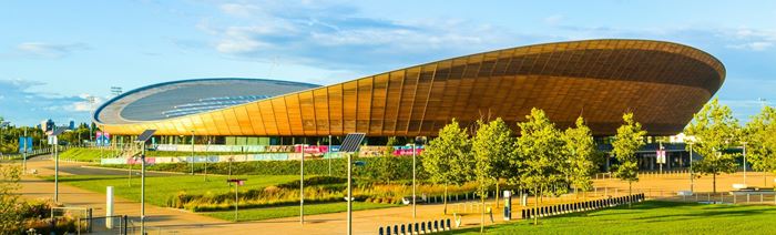 London's Lee Valley VeloPark exterior in the sunshine and surrounded by trees.