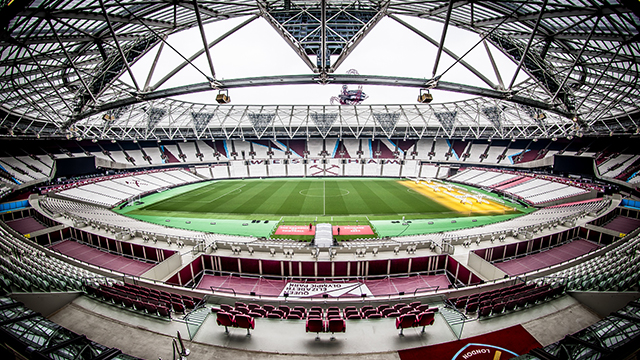 Watch West Ham United F.C. play at London Stadium. Image courtesy of Marcelo Graciolli/London Stadium. A fish-eye image of the inside of London Stadium, with West Ham United FC claret-coloured seats and a football pitch.