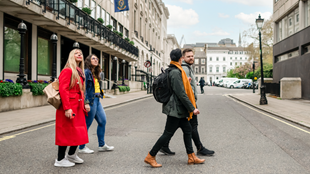 A group walking along a river bank on a Royal walking tour