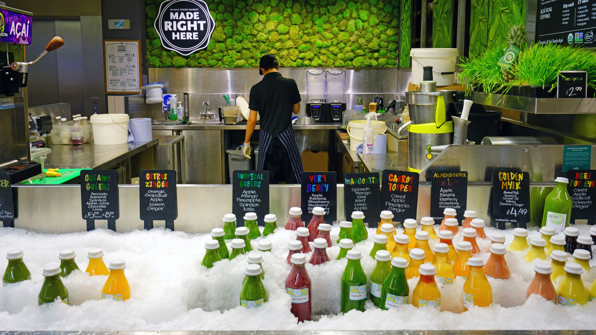 Pick up a freshly squeezed juice while you browse the shelves at Whole Foods Market. Credit: Shutterstock. Image courtesy of Shutterstock. A juice station at Whole Foods Market with a person making fresh juice and a freezer with colourful juices ready to pick up in the foreground