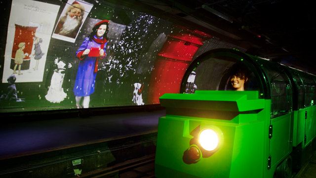 Green Mail Rail ride travelling past interactive festive screens.