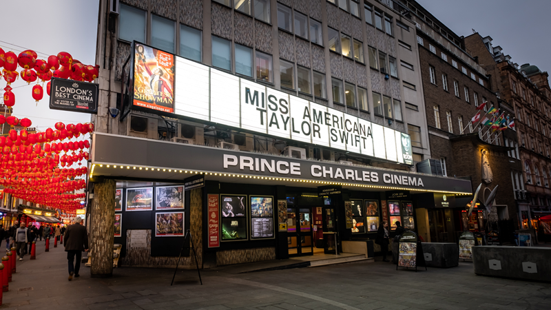 Grab affordable tickets to The Prince Charles Cinema in Chinatown for a fun-filled movie night with friends. Credit: Shutterstock. Image courtesy of Shutterstock. A photo of the front exterior of Prince Charles Cinema in Chinatown with a retro backlighted board with the films showing and red Chinese lanterns lining the street in the background