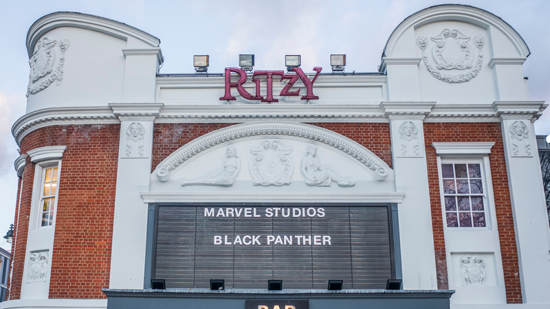 Catch a unique selection of films and documentaries on show at the historic Ritzy Cinema before continuing the fun upstairs. Credit: Shutterstock. Image courtesy of Shutterstock. A photo of the front exterior of Ritzy Cinema with its original proscenium arch, a black board spelling out the name of the films on show and red Ritzy lettering