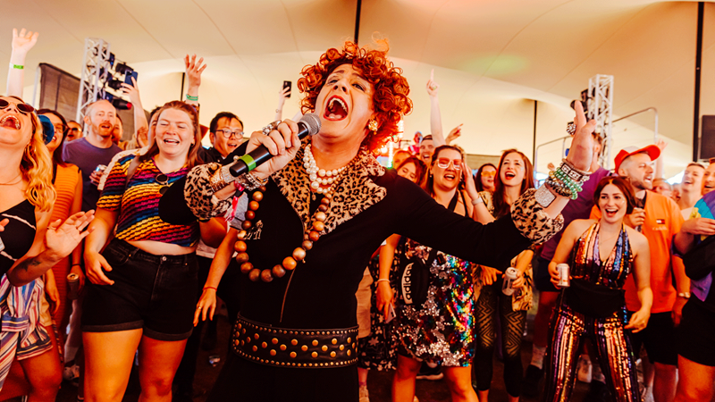 Enjoy a day filled with drag queens, glitter and great tunes at Mighty Hoopla. Credit: Captured by Corinne. Image courtesy of Captured by Corinne. Drag queen performs in front of excited festival crowd