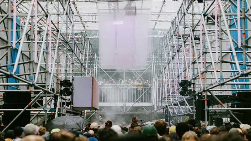 Meet likeminded ravers in the dance at Rally for a day of electronic music. Credit: Sienna Lorraine Gray. Image courtesy of Khroma Collective. A photo of a stage at Rally festival made from scaffolding with crowds in the middle of the structure and a woman singing into a microphone on a stage