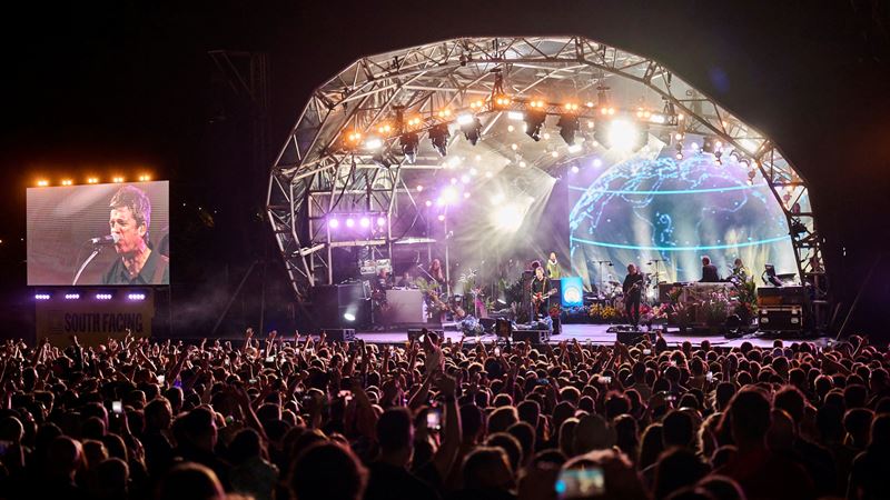 Join the crowds that flock to Crystal Palace Park for South Facing Festival's series of showstopping summer events. Credit: Tom Webb. Image courtesy of South Facing Festival. A photo of a huge crowd of people watching Noel Gallagher and the High Flying Birds onstage at South Facing Festival