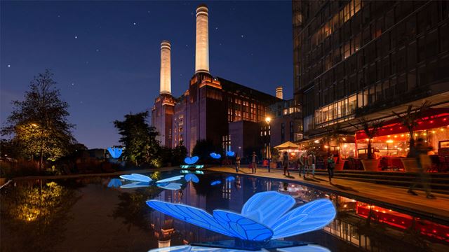 Butterfly lights in water with backdrop of Battersea Power Station.