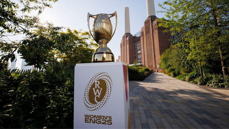 Gold cup on Women's Rugby World Cup stand in front of Battersea Power Station.