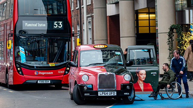 All licensed taxis in London are wheelchair accessible. Image courtesy of Shutterstock. Man in a wheelchair getting into a black cab in London.