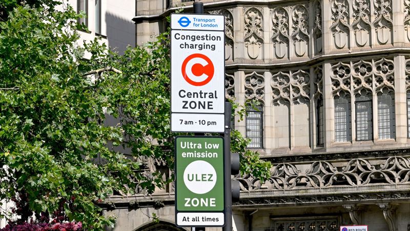 Make sure to check London's congestion charge information before your travel to the city. Credit: Shutterstock. Image courtesy of Shutterstock. A photo of two road signs showing details of congestion charge and ULEZ zone