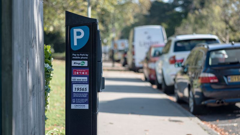 Follow the straightforward instructions to pay for parking at meters across London. Credit: Shutterstock. Image courtesy of Shutterstock. A photo of the side of a parking meter in Croydon with cars parked up at the side of the road in the background