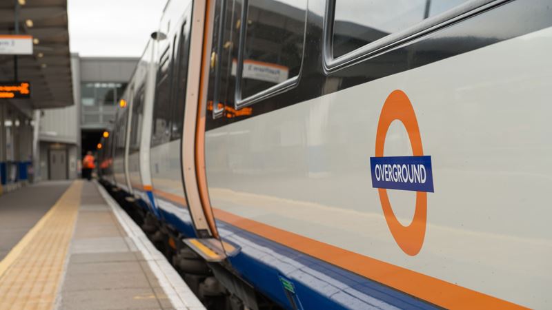 Hop aboard the London overground network to travel between London's outer boroughs. Credit: Shutterstock. Image courtesy of Shutterstock. A photo of the side of an orange London overground train on a platform
