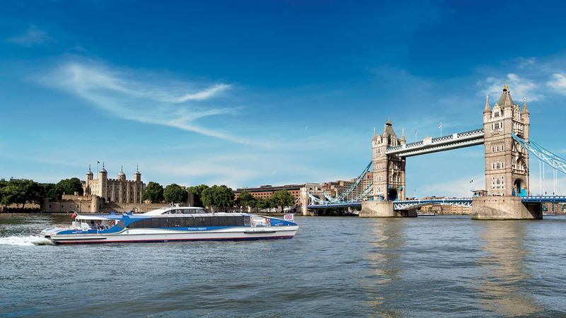 An image of Thames Clippers' Galaxy river boat approaching Tower Bridge, taken from river level.