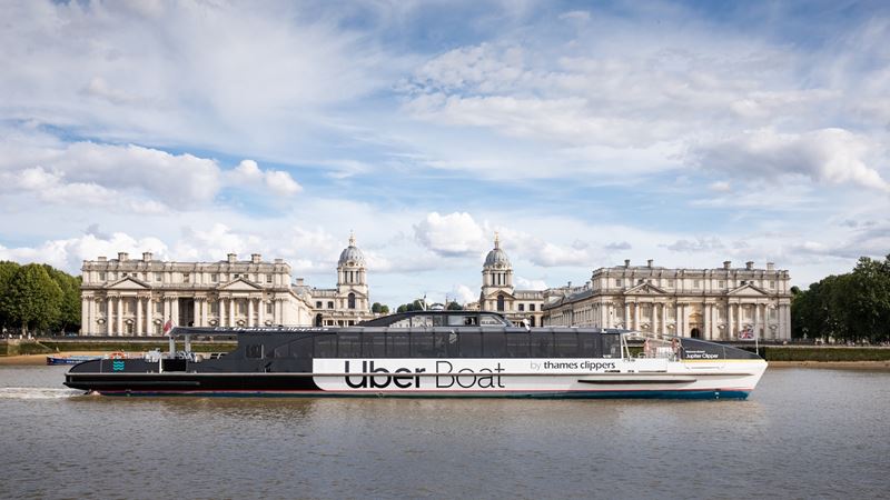 Float past iconic London landmarks. Credit: Uber Boat by Thames Clippers. Image courtesy of Uber Boat by Thames Clippers. The Uber Boat by Thames Clippers river bus floats along the river Thames past the Old Royal Naval College.