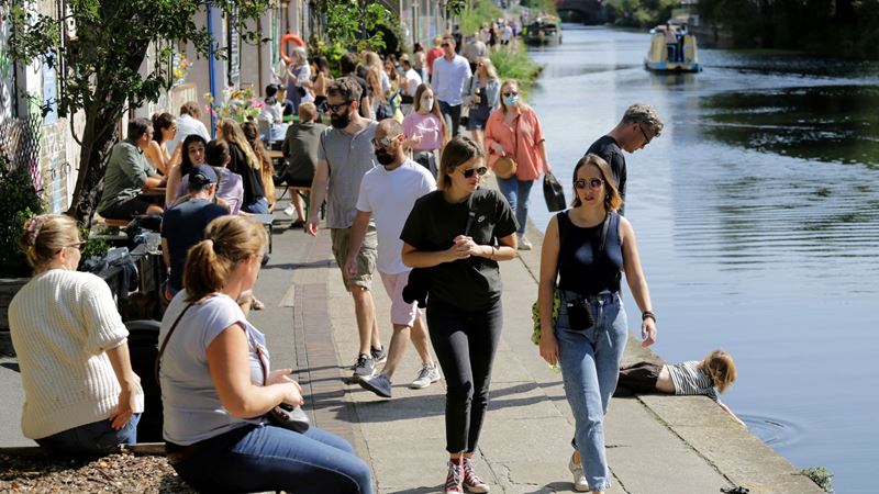 Walk the length of one of London's canals or rivers while the sun is shining. Credit: Shutterstock. Image courtesy of Shutterstock. A photo of lots of people dressed for summer walking and sat along Regent's Canal as the sun shines down on them