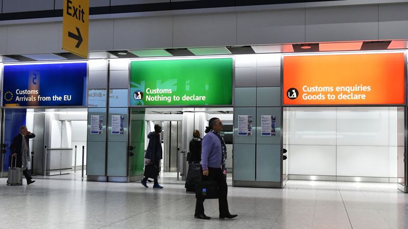 A photo of the three different customs entrances in a London airport arrivals hall
