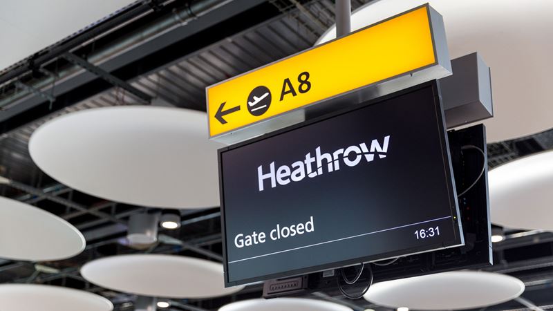 A photo of a digital sign at Heathrow Airport with an arrow pointing to gate A8 with the Heathrow logo and "gate closed" written beneath