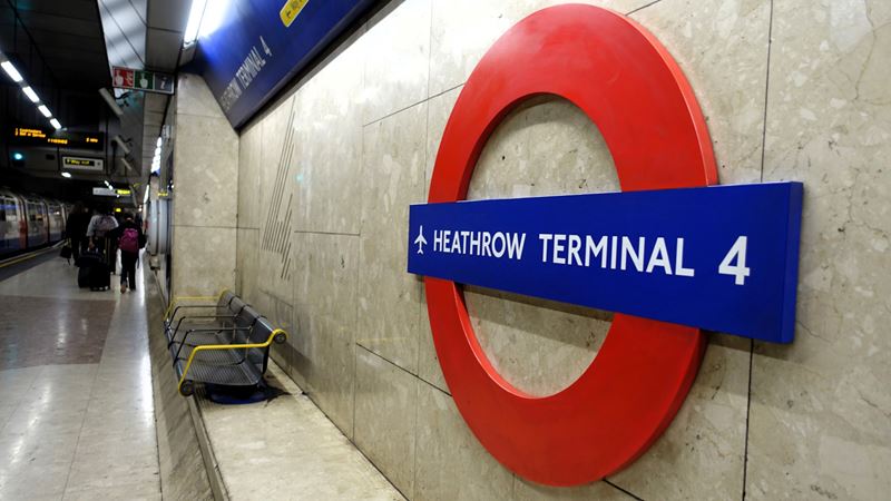 Travel to and from Heathrow Airport using the London Underground network. Credit: Shutterstock. Image courtesy of Shutterstock. A photo of a London Tube roundel hanging on the wall of the Heathrow Terminal 4 platform