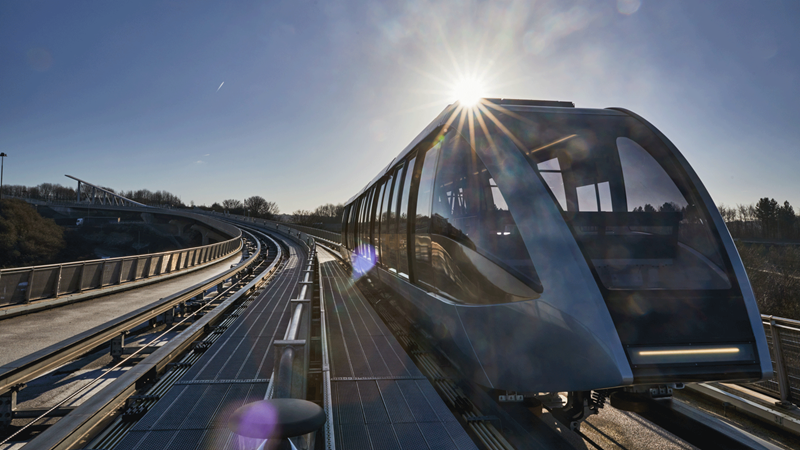 Hop aboard the many transport links to and from Luton Airport. Credit: Luton Airport Express. Image courtesy of London Luton Airport. Sun shining down onto a modern looking train with large windows