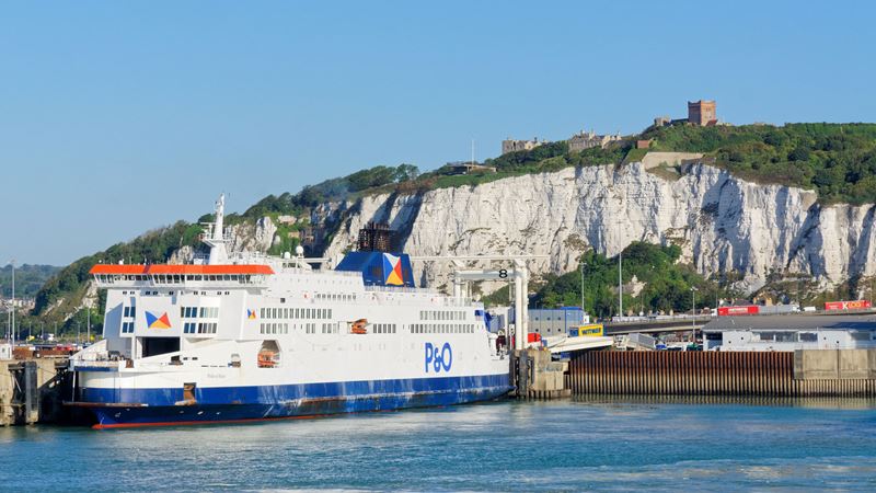 A photo of a P&O ferry docked up at Dover with the cliff and castle in the background