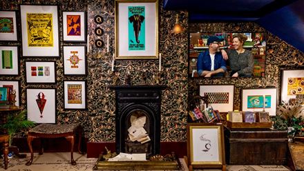 Explore walls covered in prints and graphics. Image courtesy of the House of MinaLima.