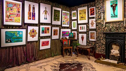 Explore walls covered in prints and graphics. Image courtesy of the House of MinaLima.