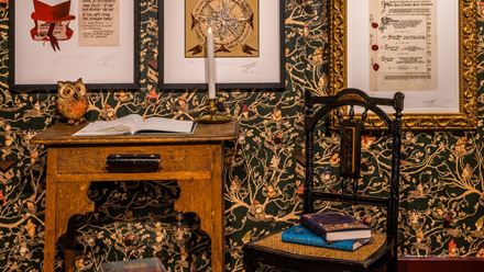 Explore walls covered in prints and graphics. Image courtesy of the House of MinaLima.