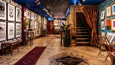 Explore walls covered in prints and graphics. Image courtesy of the House of MinaLima.