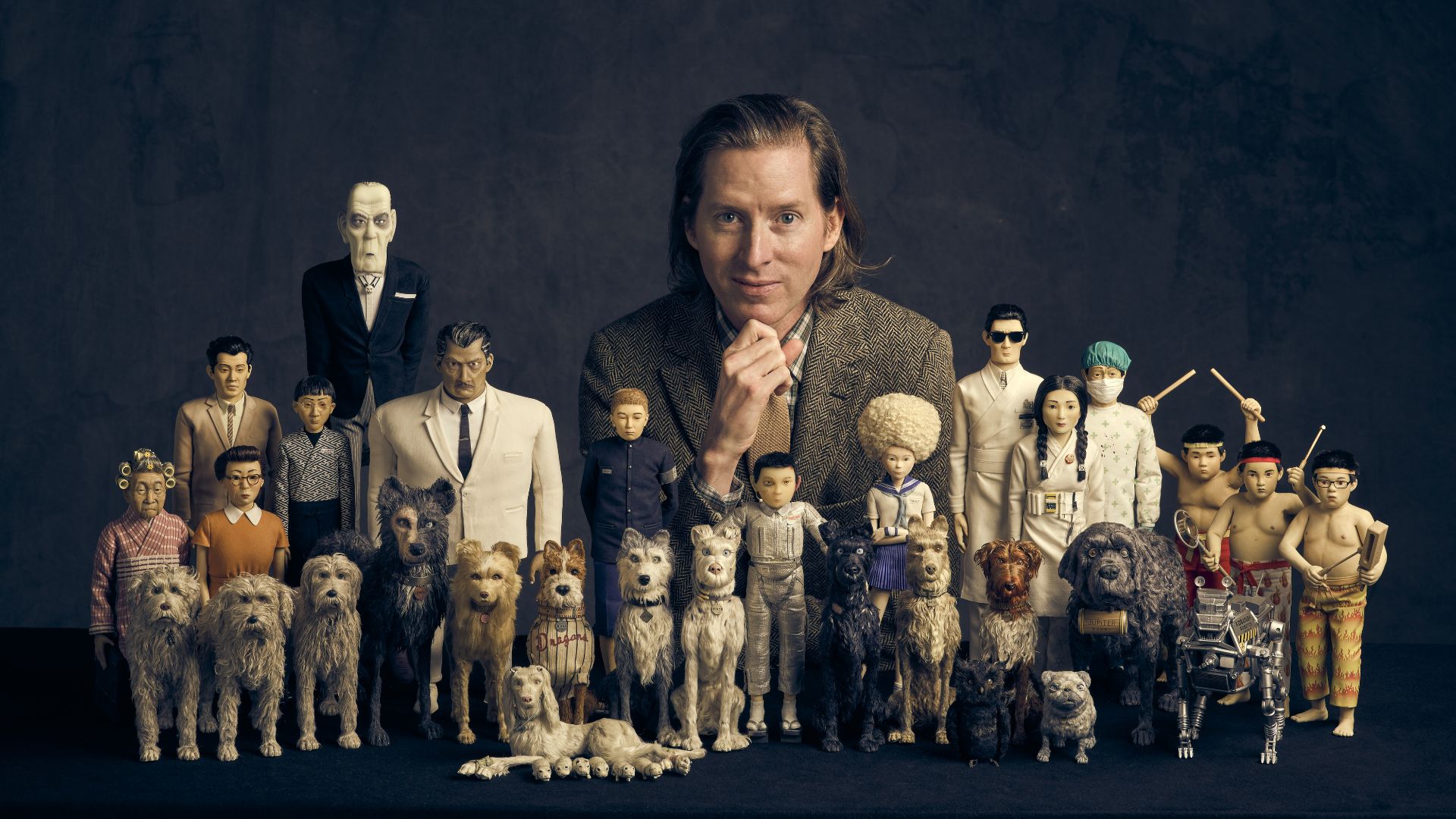 Wes Anderson: The Archives at the Design Museum. Image courtesy of Design Museum/Charlie Gray. A digital image of director wes anderson and figures of his famous film characters.