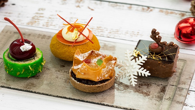 afternoon tea including four sweet pastries, including a chocolate Rudolph brownie and green tartlet with a cherry at the InterContinental at The O2