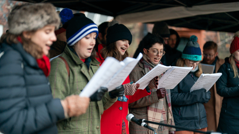 Carols in the courtyard, Fulham Palace. Credit: Marcus Dawes. Image courtesy of Fulham Palace House & Garden. Revelers sing carols in Fulham Palace courtyard