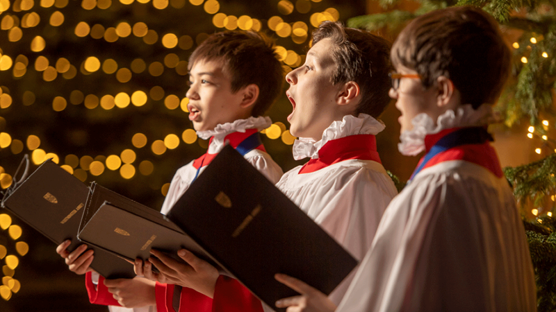 Three young boys sing Christmas carols at Westminster Abbey