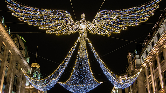 Regent Street Christmas lights © Shutterstock Angel-shaped white and yellow lights hang above Regent Street at night.