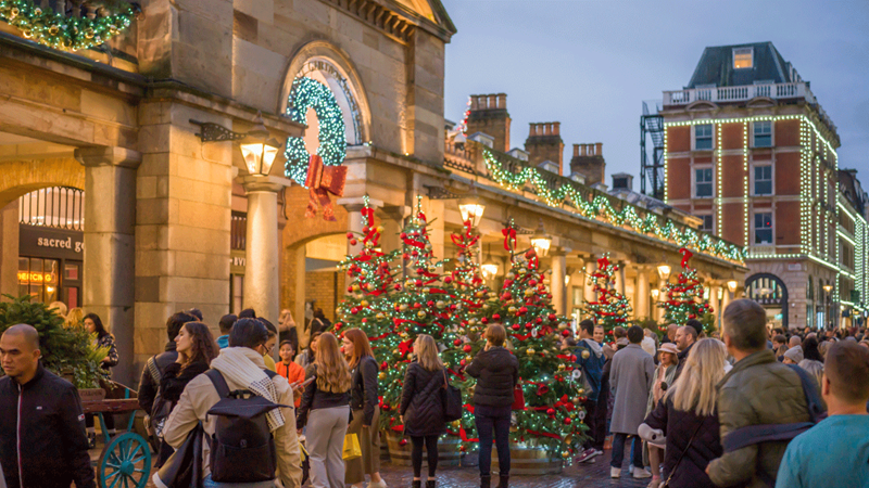 Covent Garden market at Christmas. Credit: Covent Garden. Image courtesy of Mission. Twinkling Christmas trees and lights line Covent Garden market