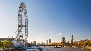 The London Eye and the river Thames with the Houses of Parliament and Big Ben visible in the distance.