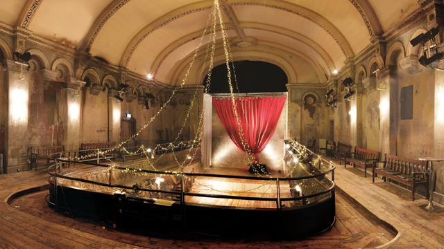 View of Wilton's Auditorium from above with many preserved traditional features including a red curtain on stage