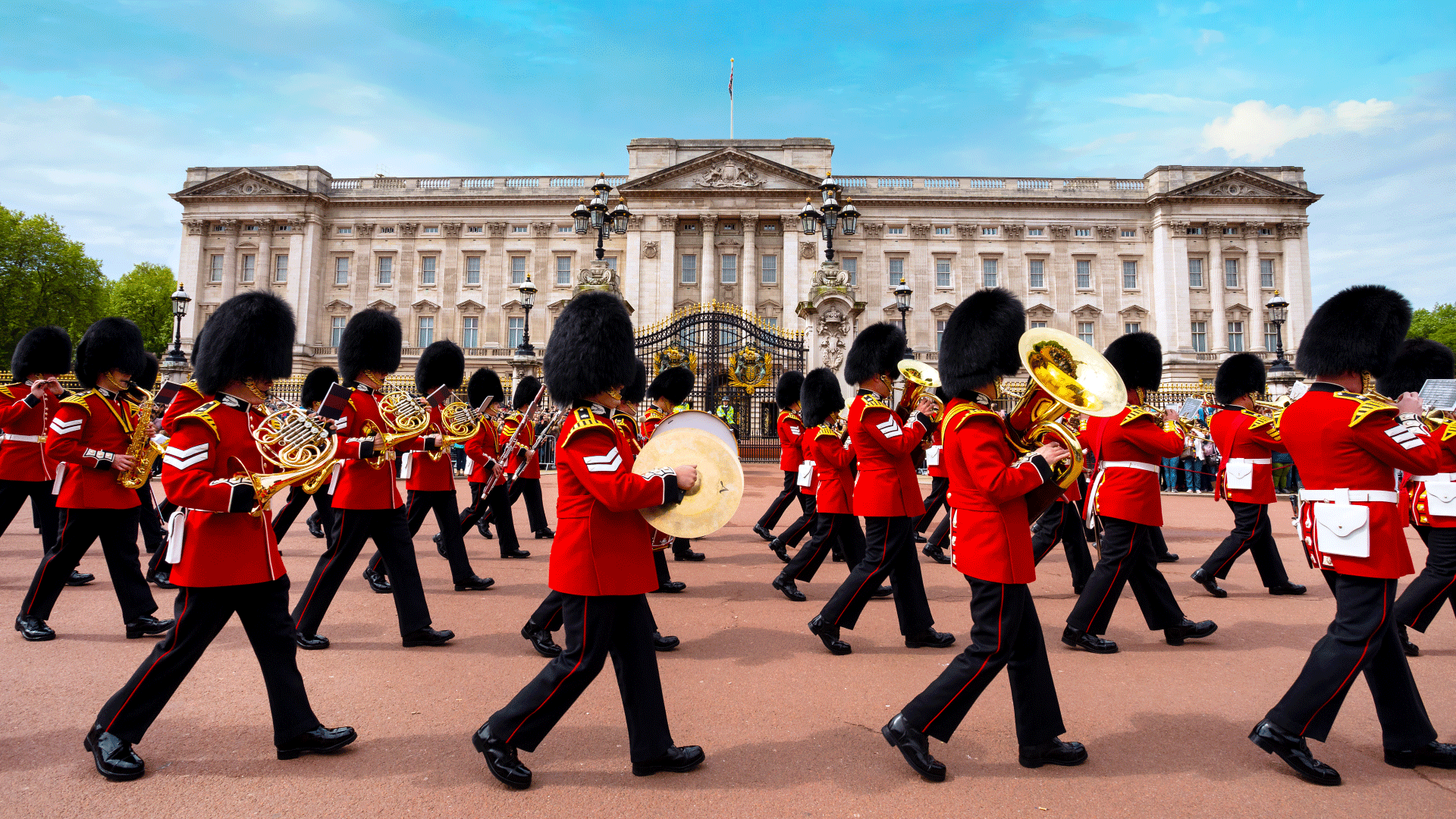 Changing the Guard at Buckingham Palace. Image courtesy of Shutterstock. Band marches in front of Buckingham Palace during Changing the Guard